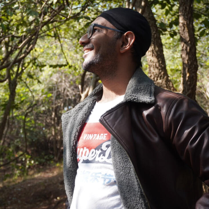 A portrait of Dhruv standing outdoors